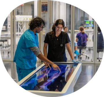 Two people interacting with a screen